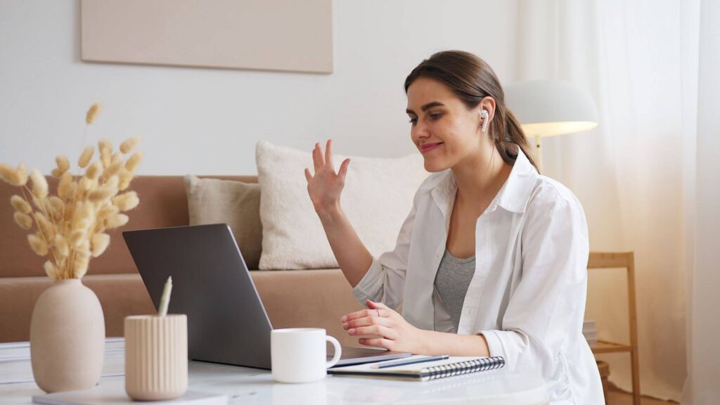 Woman smiling during a video call at home